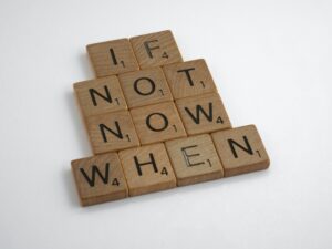 Scrabble blocks spelling "if not now, when"